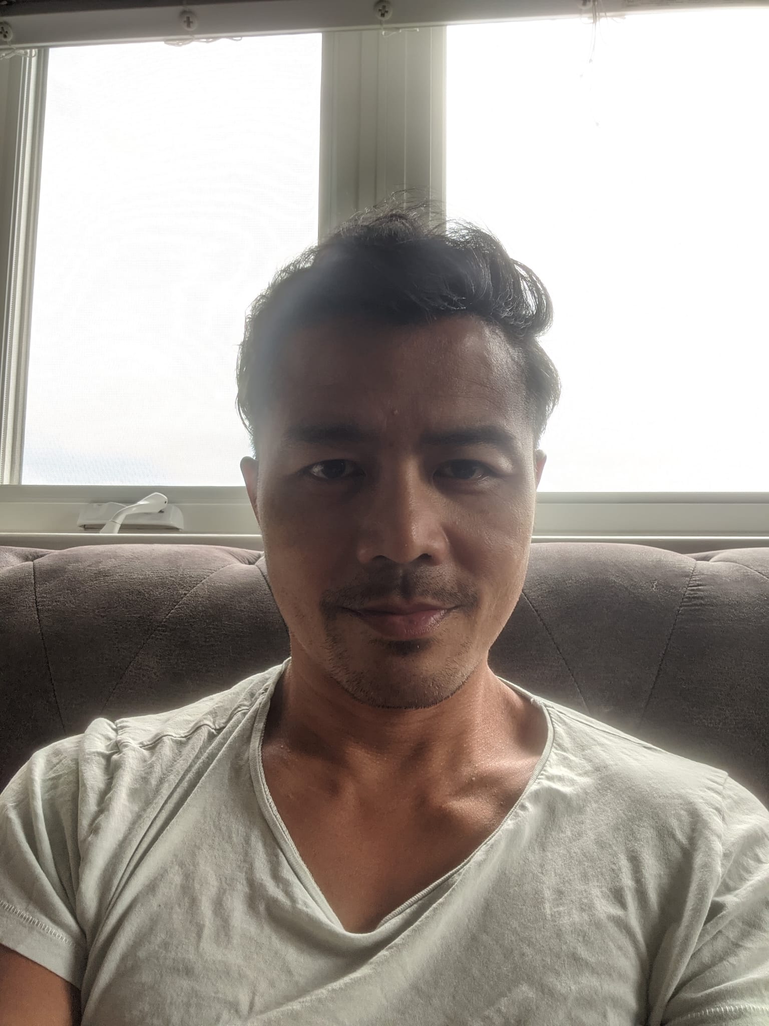 Leandro sitting on a couch.
